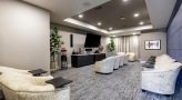 large room with chairs and a large TV