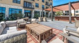 Lounge area next to the pool with patio furniture
