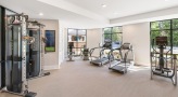 Large fitness center with large windows and plenty of equipment
