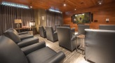 large room with reclining seats and a large tv