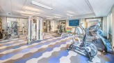 Large fitness center with large windows and plenty of equipment