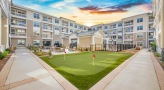 The putting green and outdoor lounge at Overture Greenville senior living apartments in Greenville, SC.