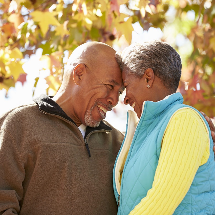 Charlotte Senior couple embracing while taking a walk in the woods.