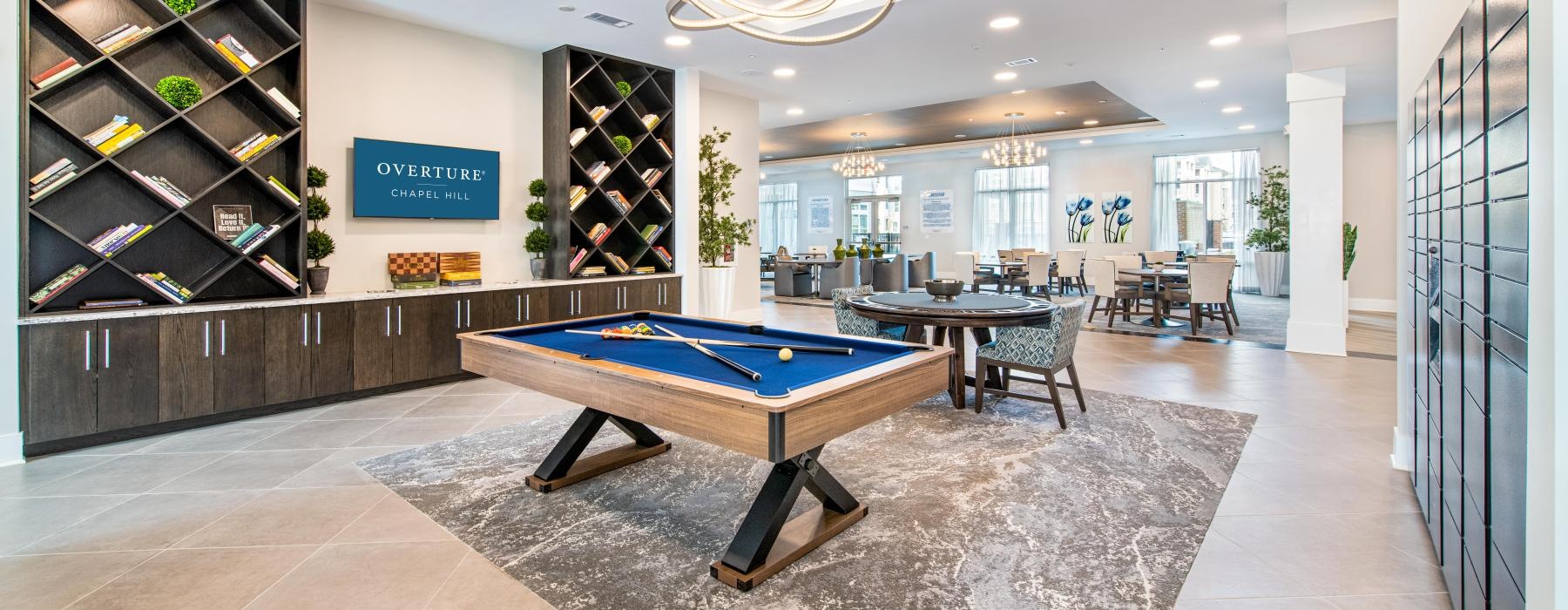 Resident lounge at Overture Chapel Hill senior living apartments in Chapel Hill, NC, featuring a billiards table.