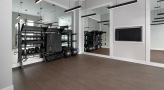 Large fitness center with large windows and plenty of equipment