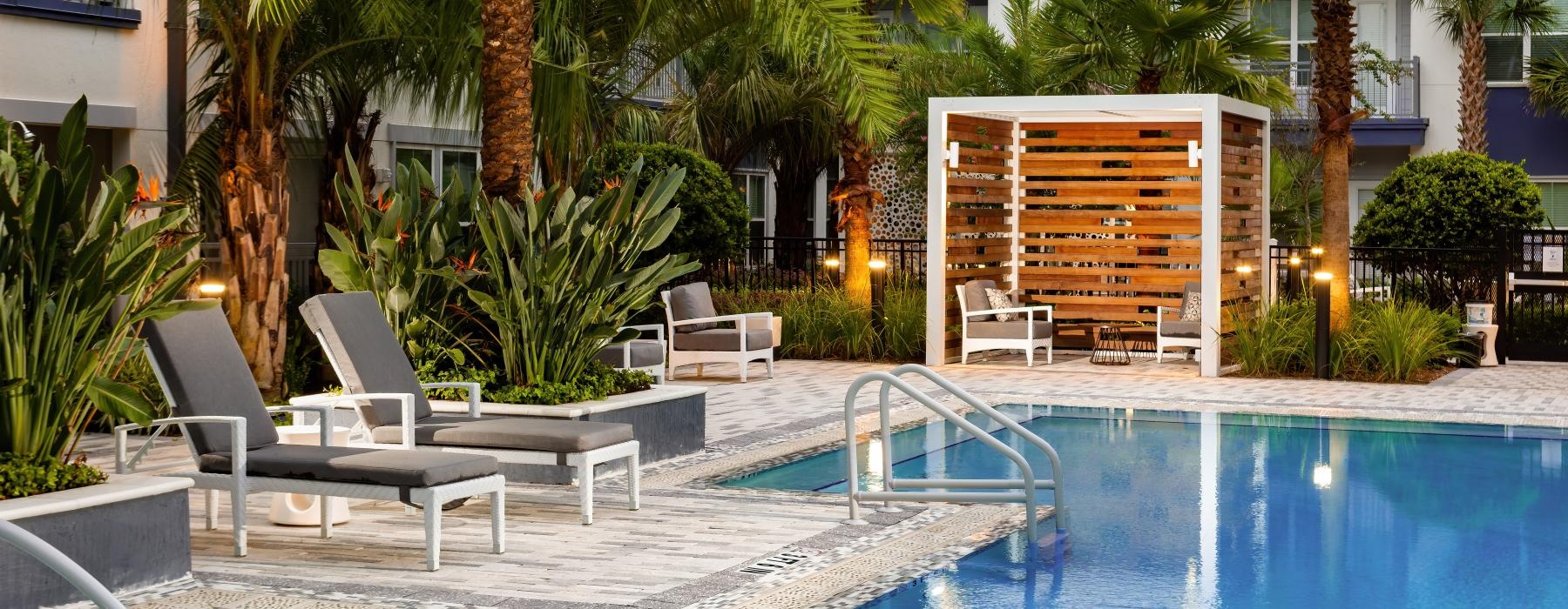 Large sparkling pool with large pool deck and lounge chairs