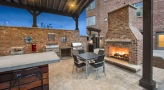 covered patio with fireplace