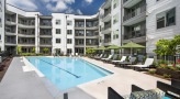 umbrella shaded lounge chairs around pool