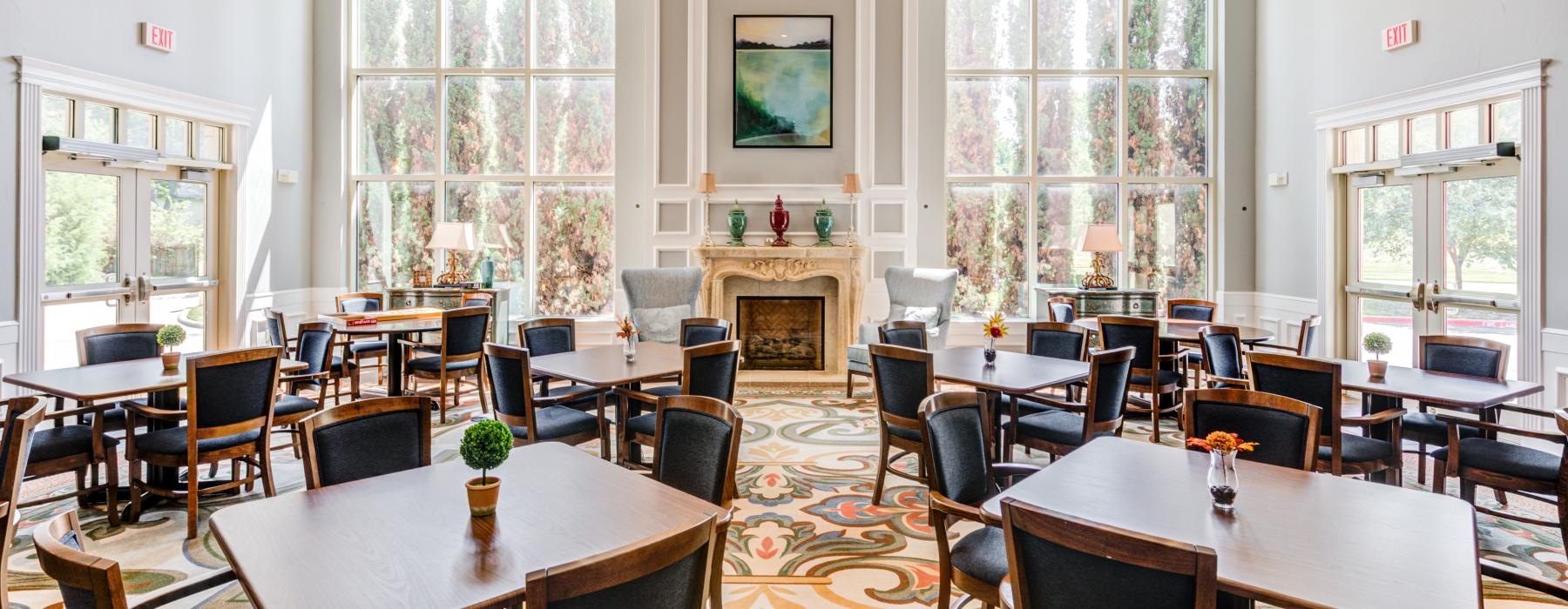  The dining area at Overture Ridgmar senior living apartments in Fort Worth, TX, featuring tables and chairs.