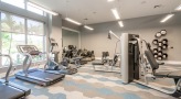 Large fitness center with large windows and plenty of equipment