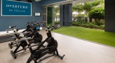 large well lit fitness center with cycling 