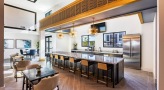 a kitchen with a bar and dining area