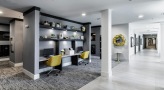 a room with a desk and chairs