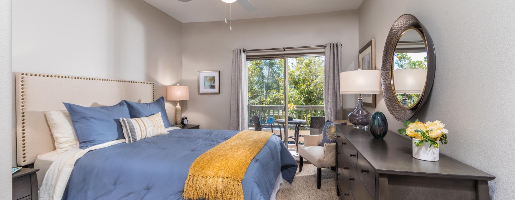 Model bedroom at Overture Rancho Santa Margarita over 55 apartments in Orange County, CA, featuring carpeted flooring.