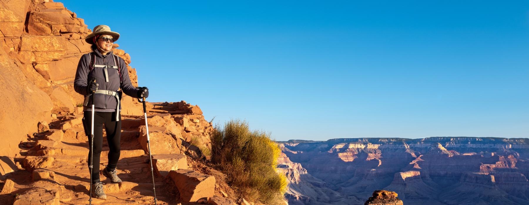 Someone hiking on a mountain near Overture North Scottsdale senior community in Arizona, featuring a blue sky. 
