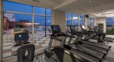 Large fitness center with large windows and plenty of equipment