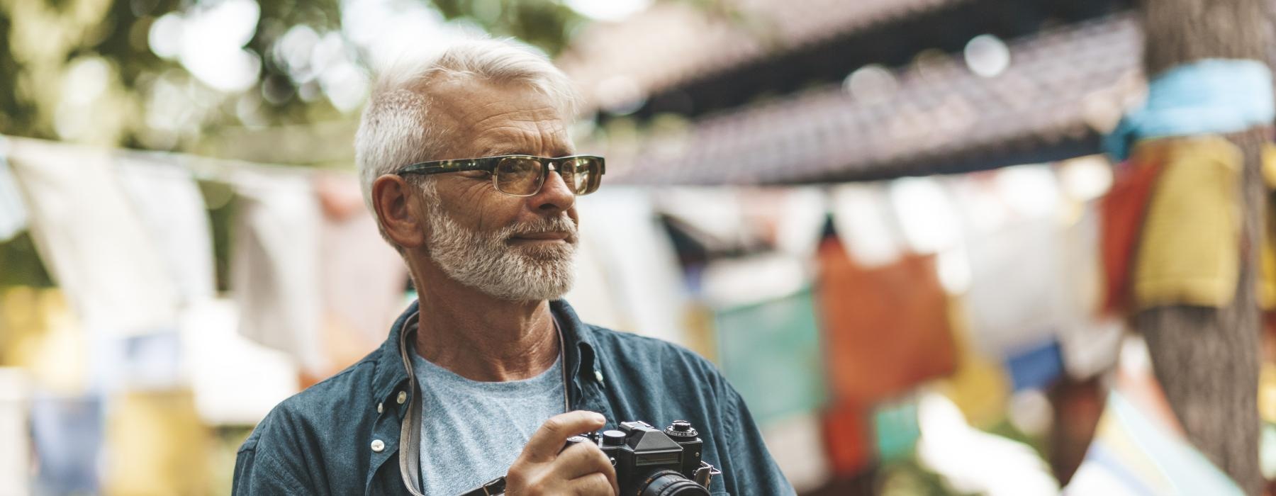A resident taking pictures outside near Overture Riverwalk senior living apartments in Riverside, CA.