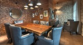large lounge with wood tables and leather chairs 