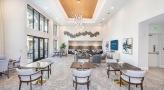 Lounge and common area at our apartments for rent in Baltimore, featuring tiled flooring and ample seating.