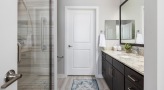 large bathroom with brown accents and closet space