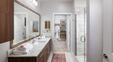 Large bathroom with double vanity sinks and a large mirror