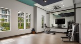 Large yoga room with wood floors and large mirrors 